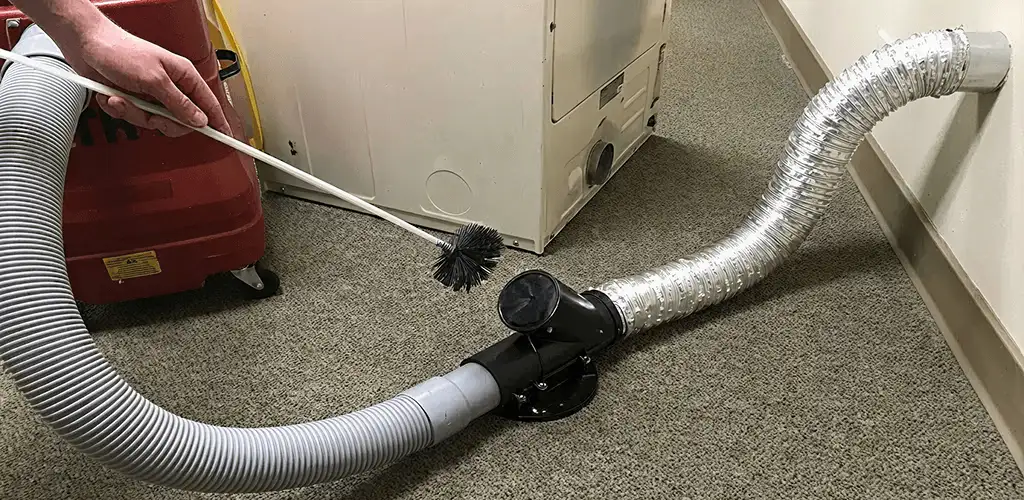 Dryer vent cleaning service removing lint from a dryer duct connection in Columbus, OH
