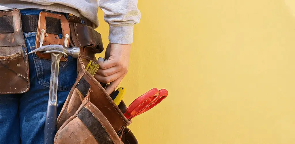 Handyman with tool belt ready for home repairs and maintenance in Columbus, OH