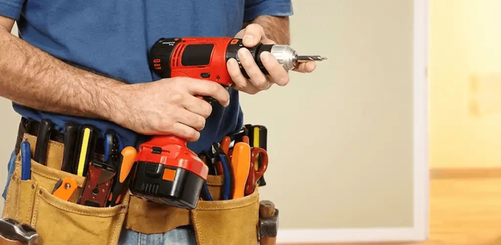 Handyman holding a power drill for home repairs and installations in Columbus, OH
