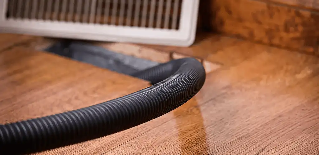 Air duct cleaning hose inserted into a floor vent for ductwork cleaning in Columbus, OH
